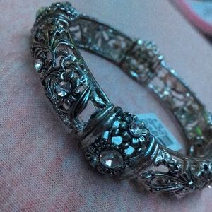 Silver toned stretch bracelet with floral pattern